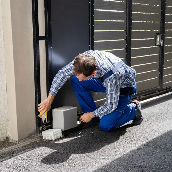 Repairman Fixing Broken Automatic Door In Building